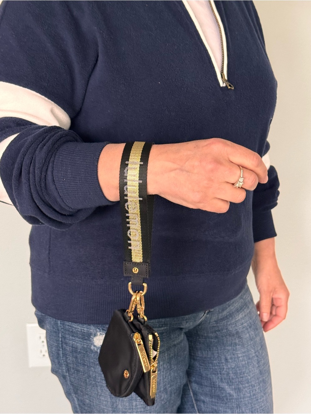 Lululemon Black Wristlet Pouch with Gold Hardware and black and gold strap.